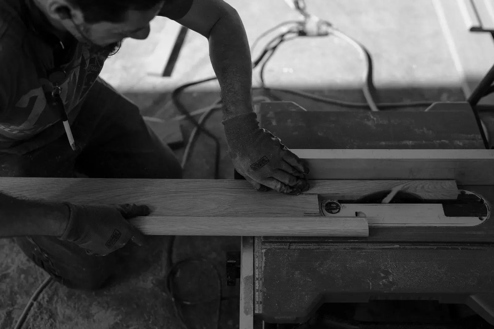 Close detail of a Good Ol' Boy craftsman cutting an oak plank