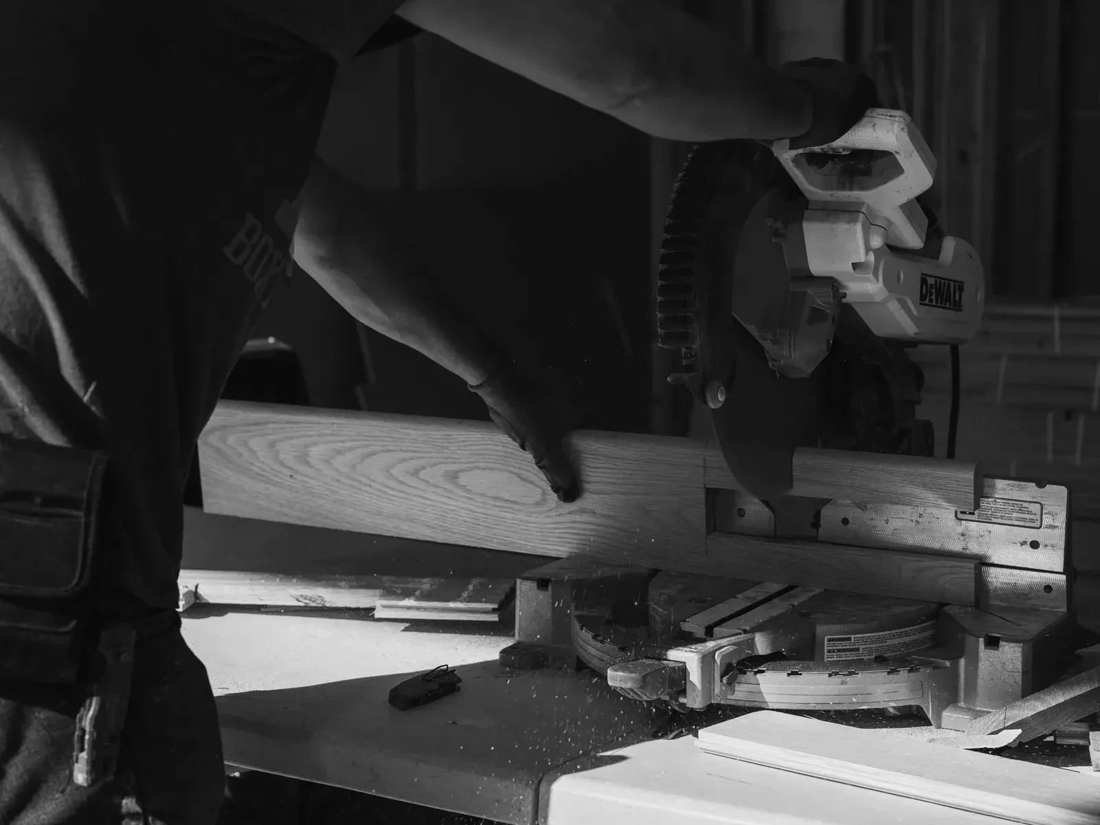 Good Ol’ Boy crew member making a miter cut on hardwood trim