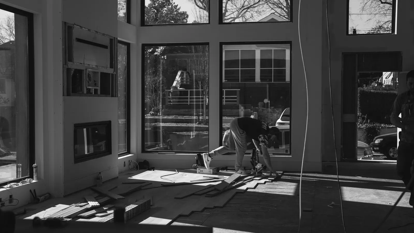 Good Ol' Boy crew nailing down hardwood flooring in a bright Kansas City home