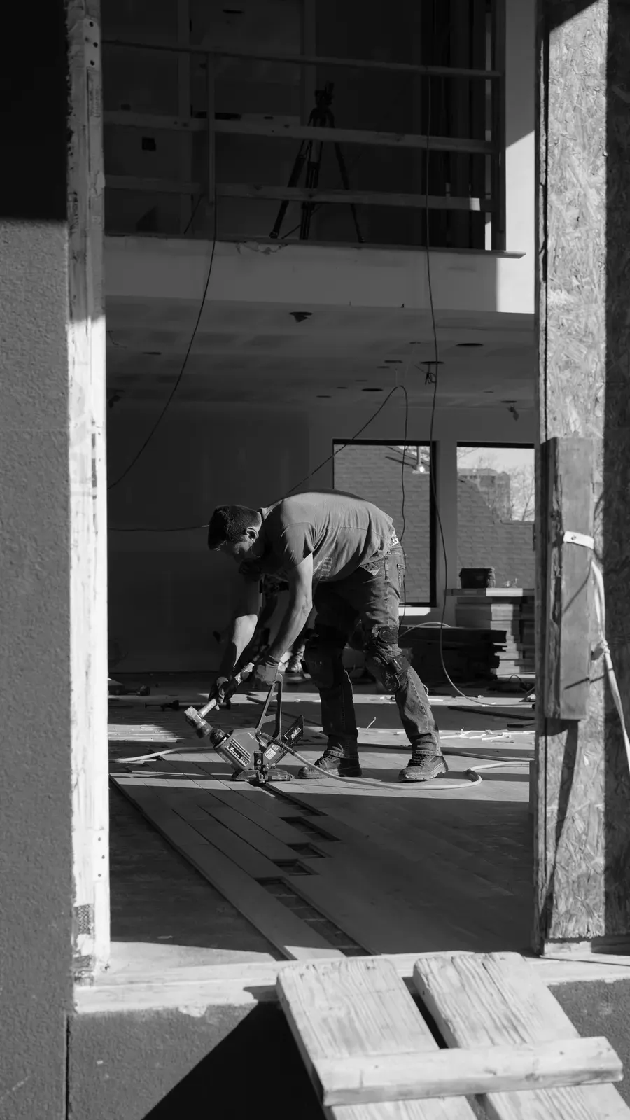 Good Ol’ Boy installer fastening hardwood flooring on a Kansas City job