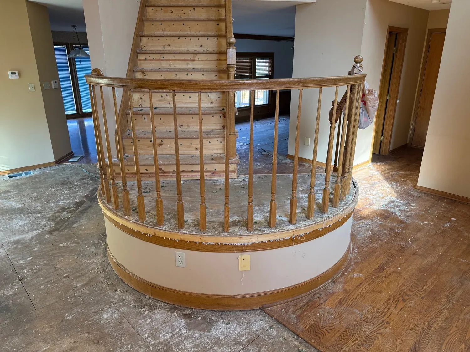 Curved staircase and landing torn down to the subfloor before restoration in Kansas City